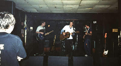 A picture of the band playing live in 1999