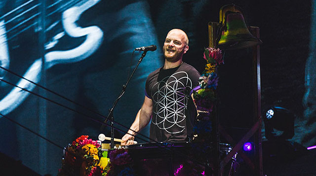 A picture of Will Champion playing percussion durring Viva La Vida at the AHFOD tour